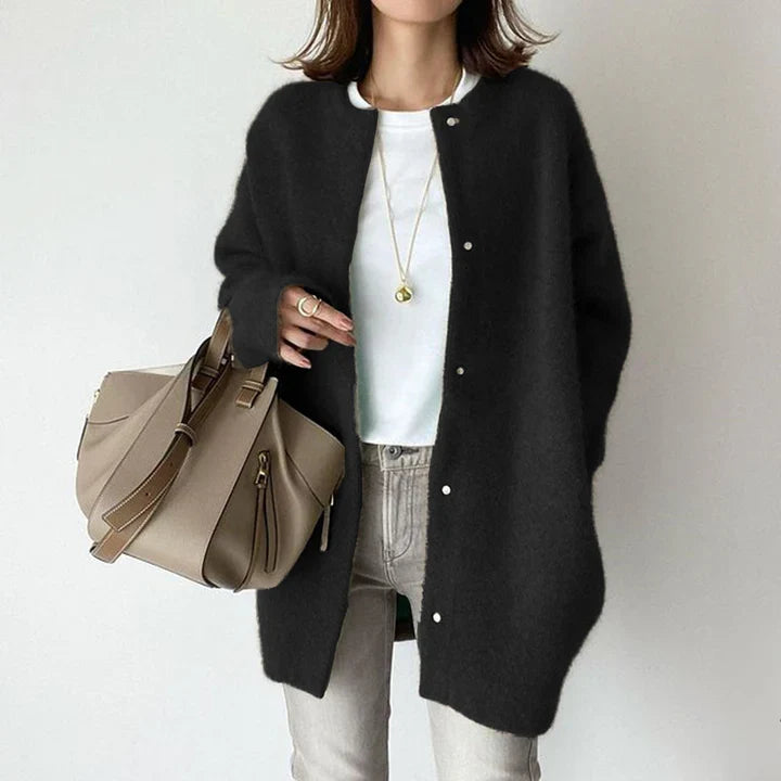 Stylish women's mid-length cardigan, button-front, offers comfortable, chic layering.
