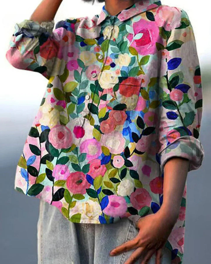 Vibrant blooming floral pattern on a women's summer blouse, lightweight and comfortable top.
