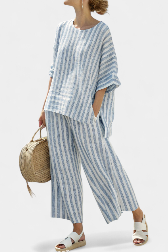 Effortless blue striped women's relaxed fit outfit set. Comfortable two-piece top and pants for coastal vacation fashion.
