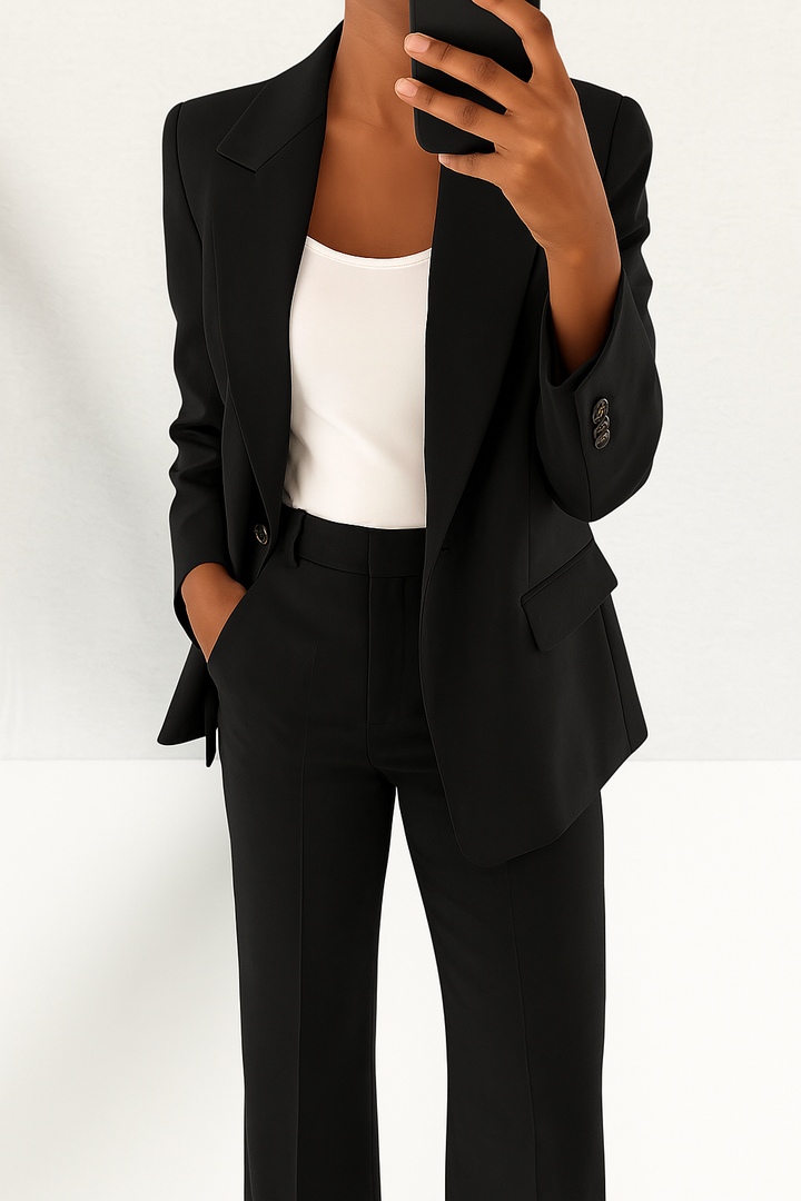 Contemporary women's tailored suit set, featuring a sleek blazer & smart trousers for versatile office wear.