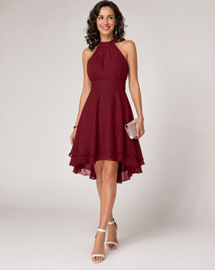 Flowy halterneck midi dress for women, featuring a beautiful pleated tiered skirt & asymmetric hem.