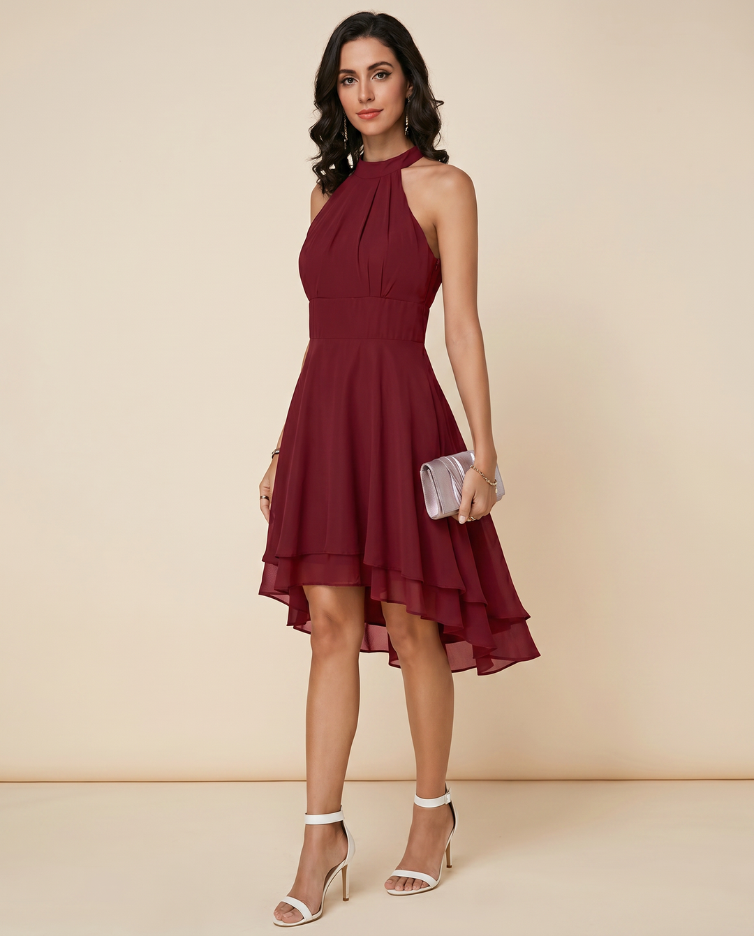 Sophisticated women's elegant halterneck midi dress with a pleated tiered skirt and asymmetric hem.