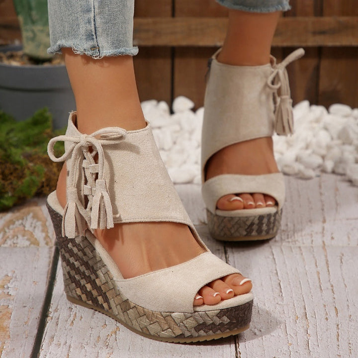 Trendy women's high wedge sandals with a comfortable design and sophisticated tassel embellishments.