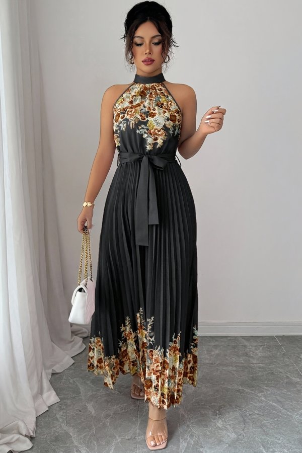 Fashionable women's floral halter midi dress, featuring a flattering pleated silhouette and tie-waist.