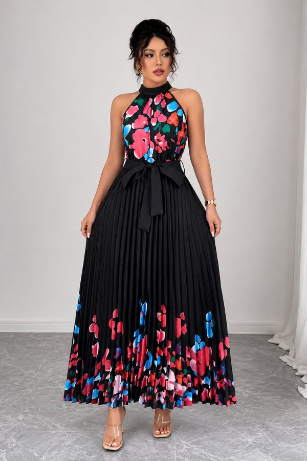 Full length shot of the women's floral pleated midi dress with a chic halter top and accentuating tie-waist.