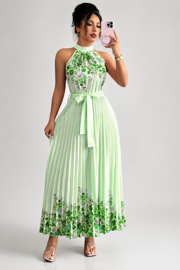 Close-up of the beautiful floral print and pleated details on this women's halter midi dress.