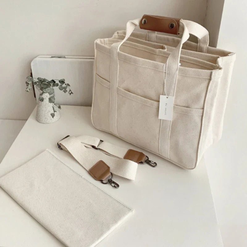 Beige multi-pocket canvas tote bag for women, spacious & stylish, ideal for daily essentials.