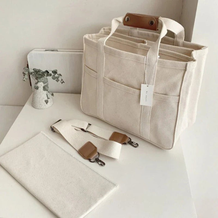 Beige multi-pocket canvas tote bag for women, spacious & stylish, ideal for daily essentials.