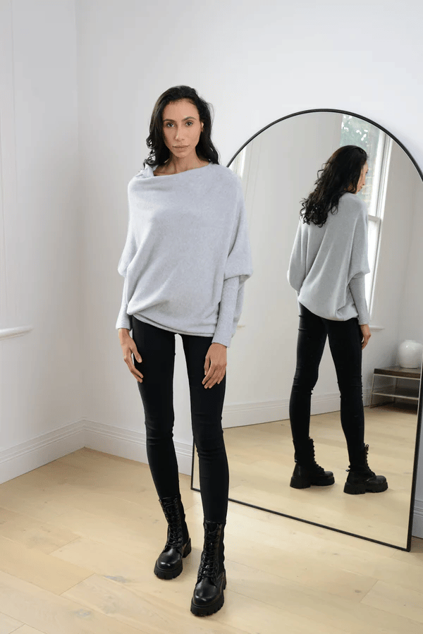 Light gray off-shoulder women's sweater, relaxed fit long sleeve knit top, versatile for casual or evening.