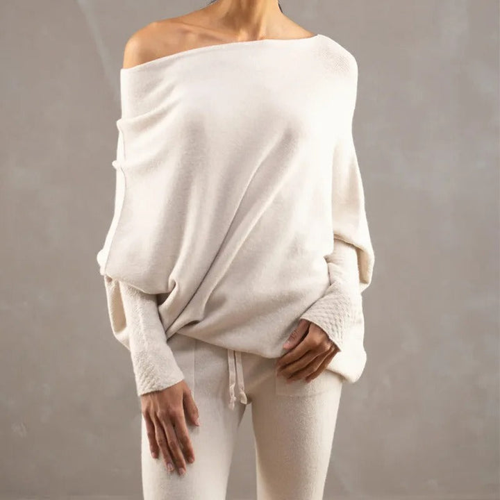 Women's elegant beige off-shoulder sweater, long sleeve knit top, a versatile piece for fall and winter style.