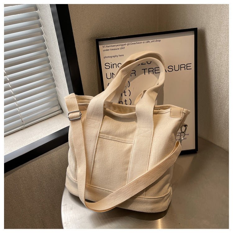 Versatile women's canvas tote bag, worn as crossbody or shoulder bag. Adjustable strap.