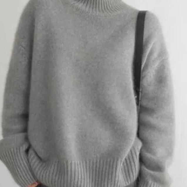Elegant women's oversized turtleneck sweater, chic apparel, relaxed fit for winter comfort.