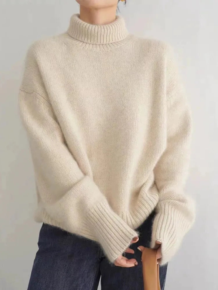 Plush women's oversized turtleneck sweater, comfortable top, chic winter fashion, versatile style.
