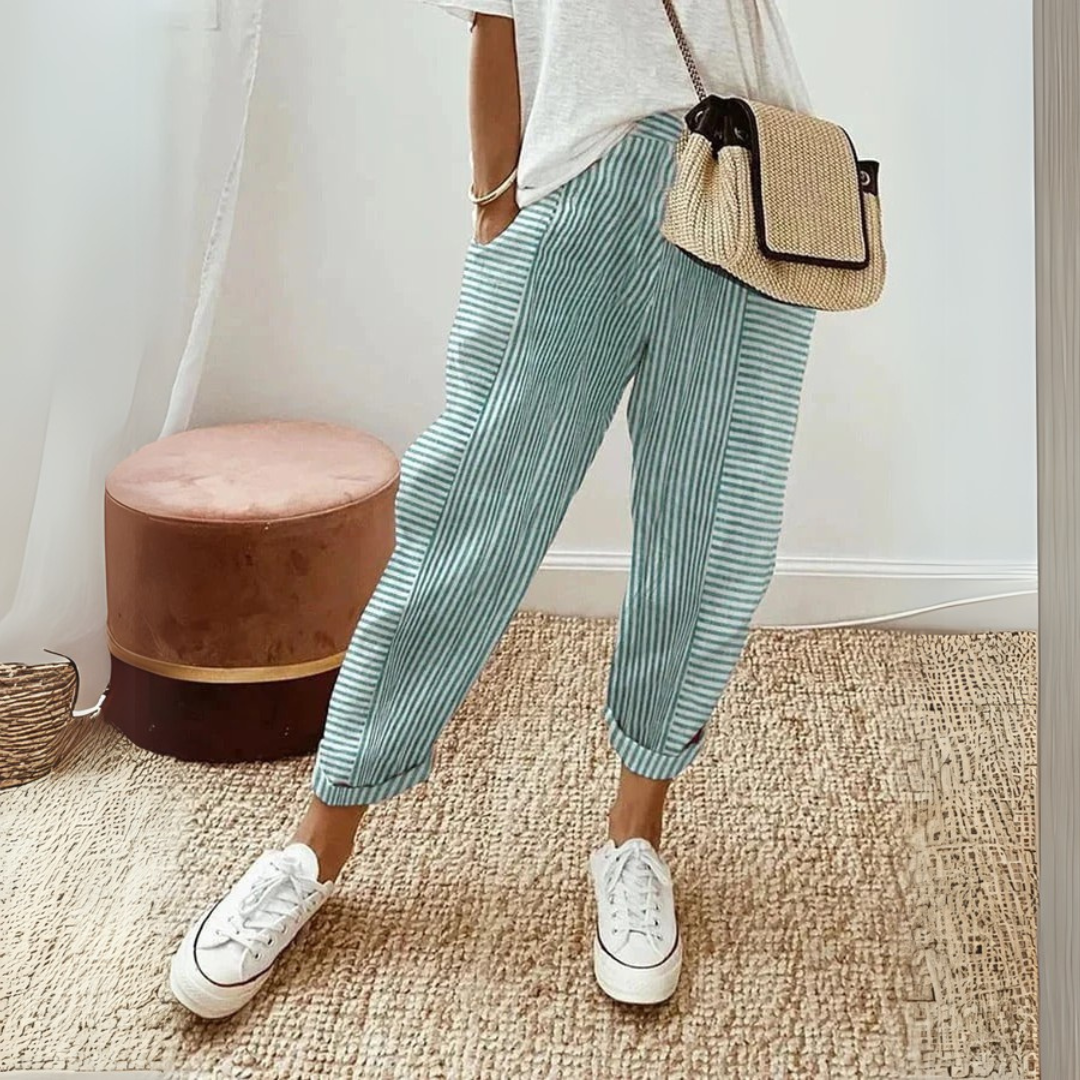 Comfortable women's striped trousers featuring a drawstring waist & pockets, ideal for casual wear.