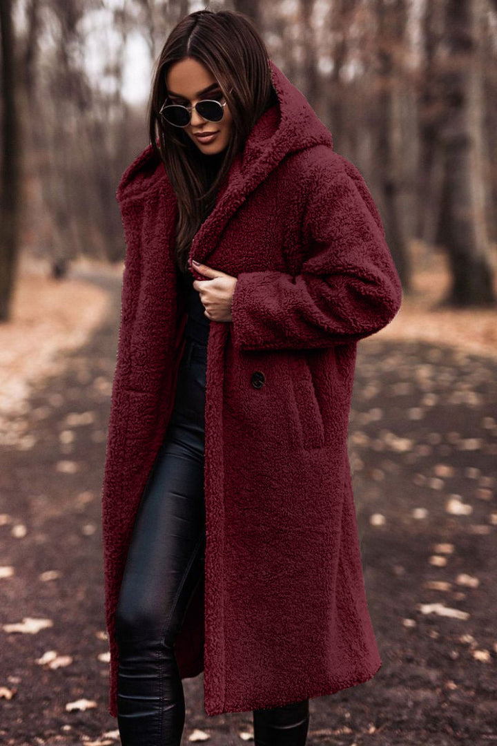 Elegant women's knee-length coat, warm for cold weather and cozy winter fashion.