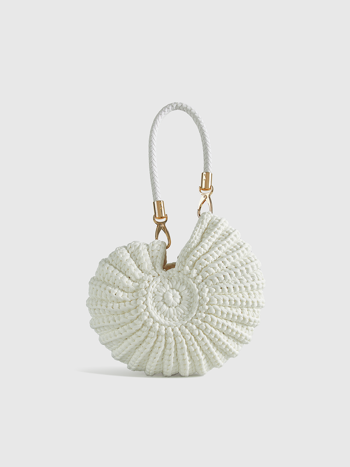 Close-up of a women's unique conch-shaped crochet bag, showcasing its intricate texture and playful design.