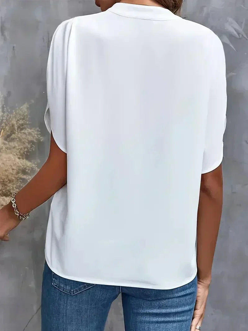 Elegant women's V-neck top featuring stylish split sleeves, perfect for casual or workwear.