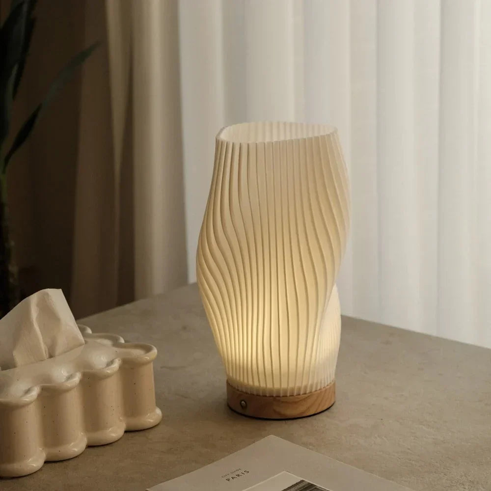Warm & natural light from a dimmable Wavecrest table lamp, stunning wave design.
