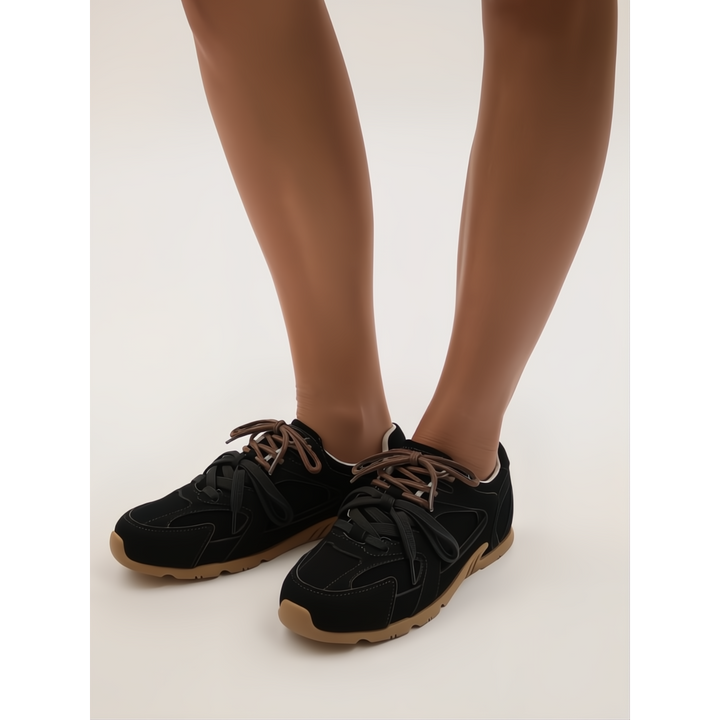 Fashionable women's low-top sneakers with a distinctive dual-lace detail, perfect for chic casual outfits.