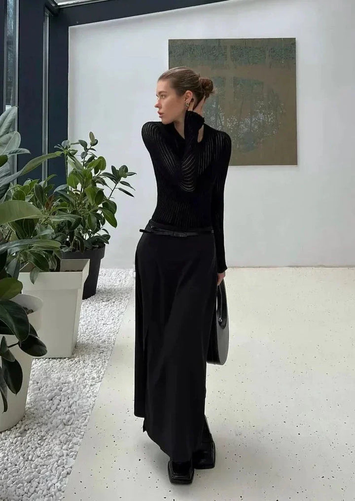 Fashionable women's sheer long sleeve top styled for versatile layering in a modern elegant outfit.