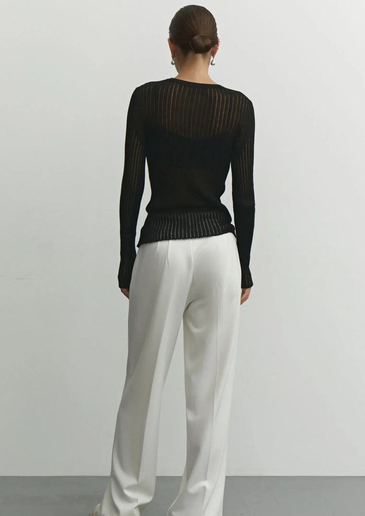 White women's sheer long sleeve top, an elegant and modern layering piece for any fashion look.