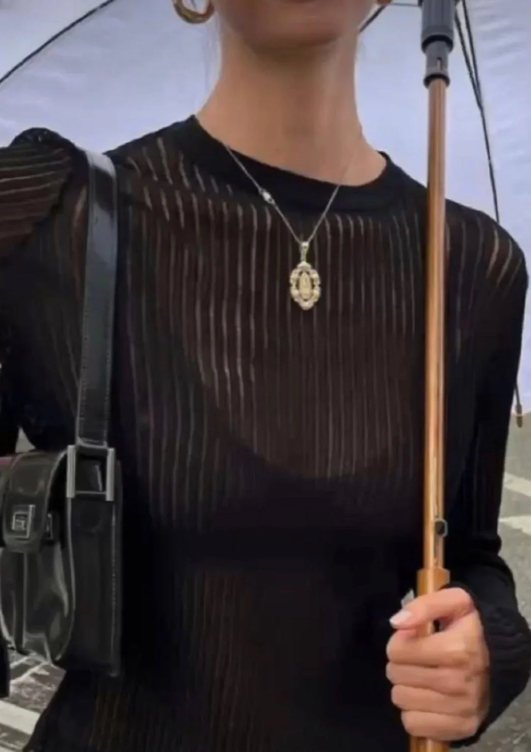 Black women's sheer long sleeve top for elegant modern layering, a versatile fashion piece.