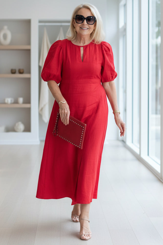 Sophisticated women's maxi dress, tailored formal wear with elegant puff sleeves.