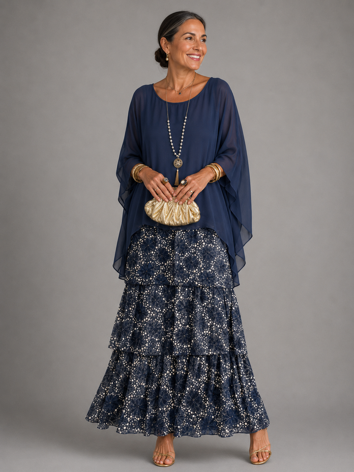 Round neck women's flowy maxi dress with long sleeves, delicate ruffle trim, and an elegant tiered skirt.