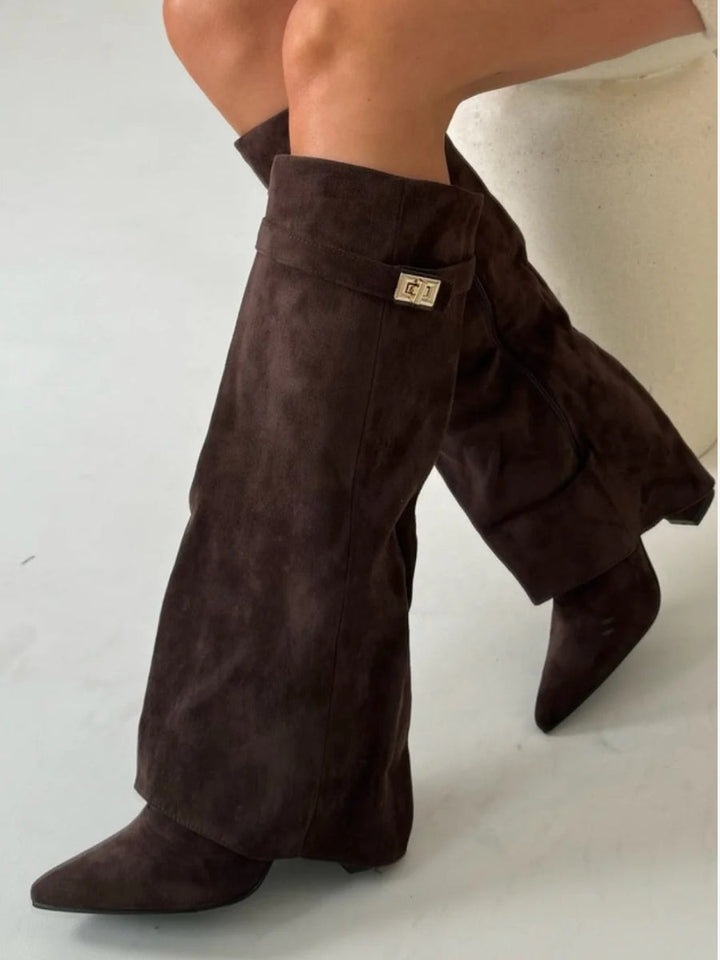 Women's chic over-the-knee boots. Pointed toe, low heel. Stylish, sleek footwear for confident steps.