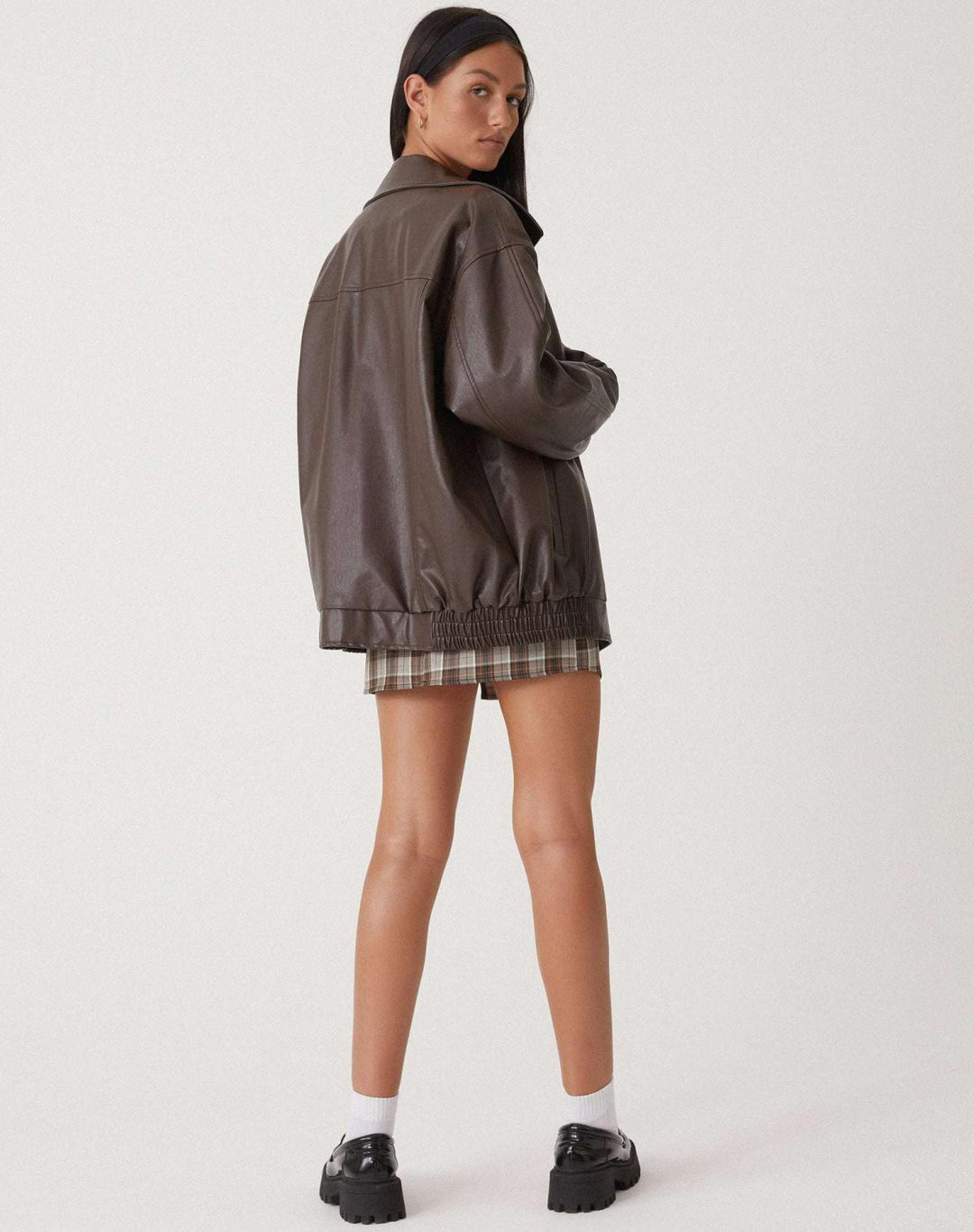 Classic women's black leather-look jacket with stylish zipper details and an oversized, modern fit.