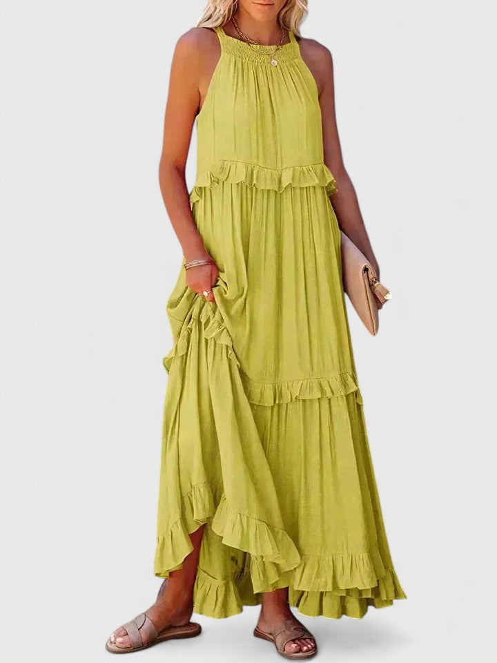 Close-up of elegant ruffle detailing on a white sleeveless women's flowy summer maxi dress.