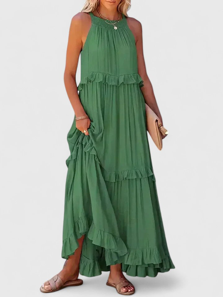 Woman enjoying summer in a comfortable, elegant white flowy ruffle maxi dress. Boho chic style.
