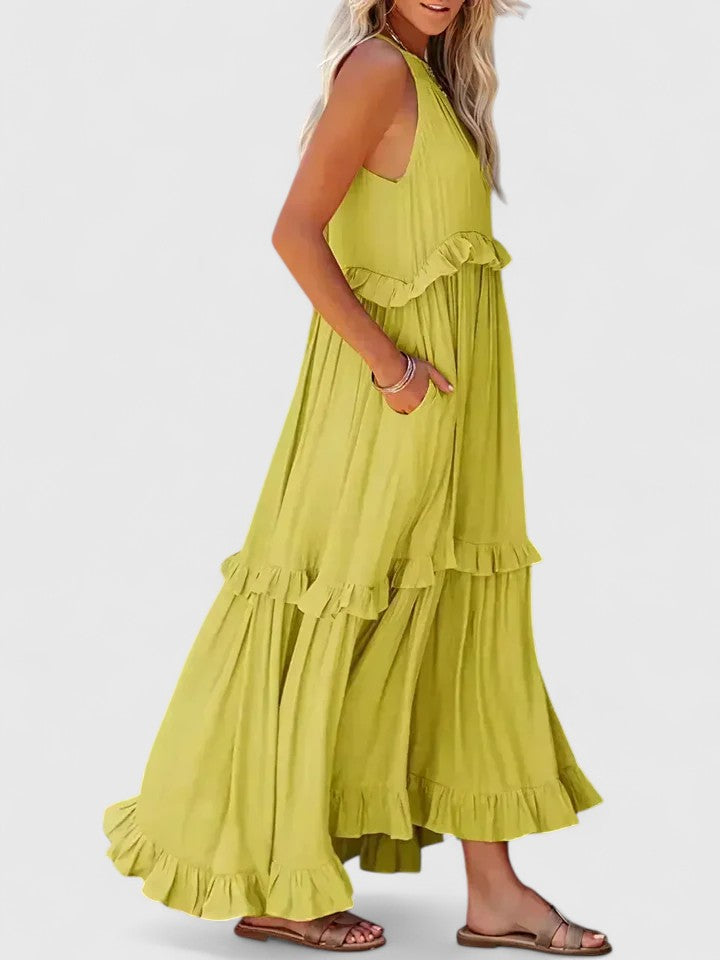 Women's elegant white flowy maxi dress from behind, showing comfortable, versatile summer style.