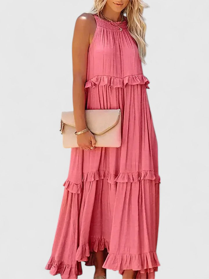 Side view of a woman wearing an elegant white flowy maxi dress, ideal for summer parties.