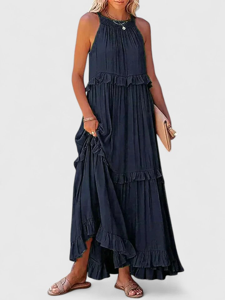 White flowy maxi dress styled casually for a comfortable, elegant summer look. Versatile women's wear.