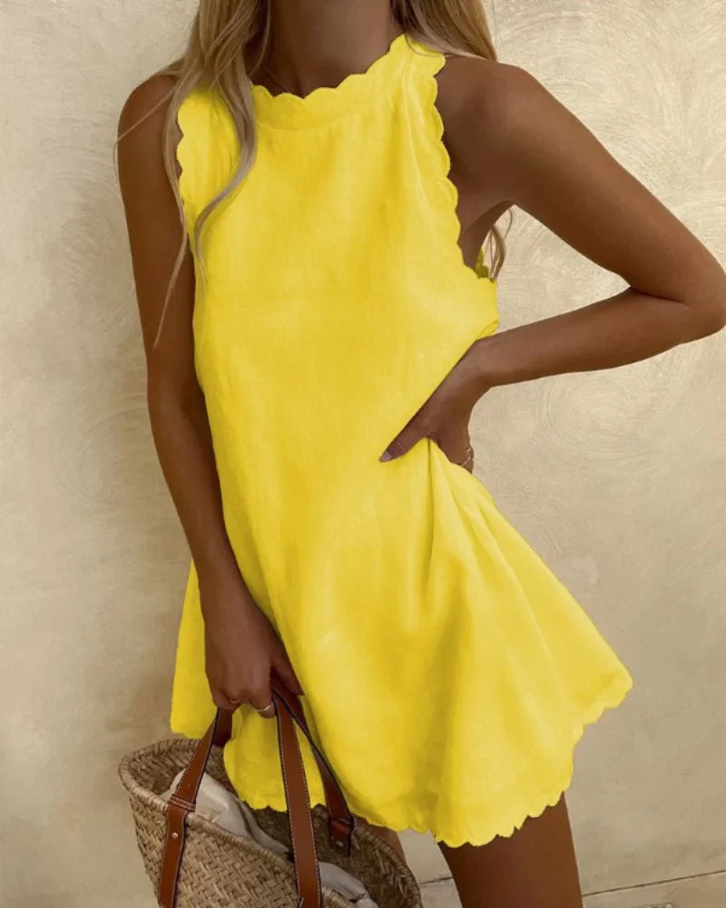 Graceful woman in a wavy trim casual mini dress, showcasing stylish spring and summer fashion.