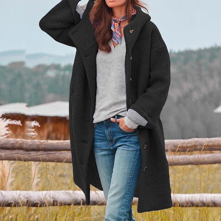 Cozy women's long hooded winter coat, offering warmth and style for casual or travel wear.