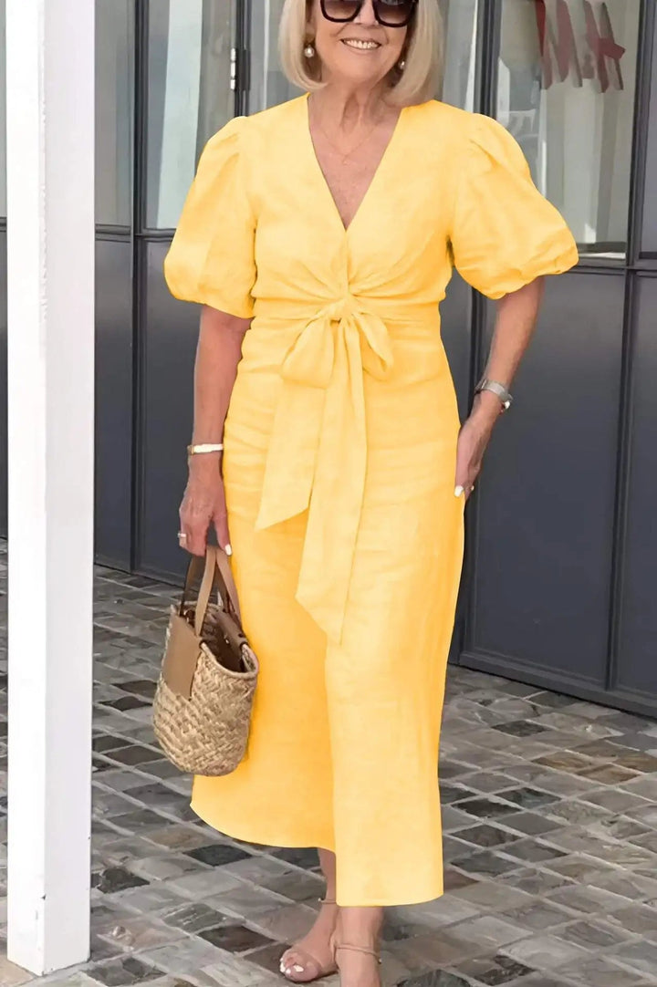 Flattering women's V-neck cocktail dress with elegant puff sleeves, perfect for any party or event.