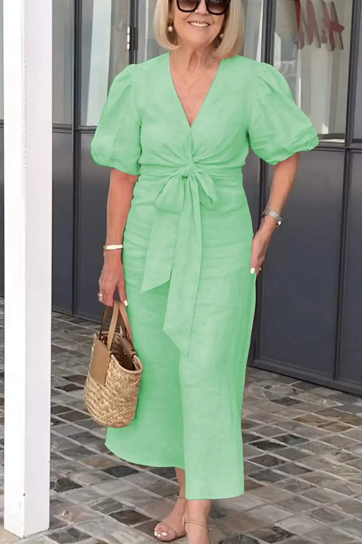 Sophisticated women's midi dress featuring a V-neck and puff sleeves, suitable for formal occasions.