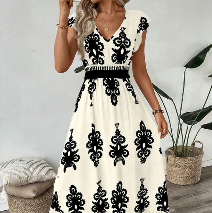 Women's elegant graphic print A-line midi dress with V-neck, a sophisticated and chic look.