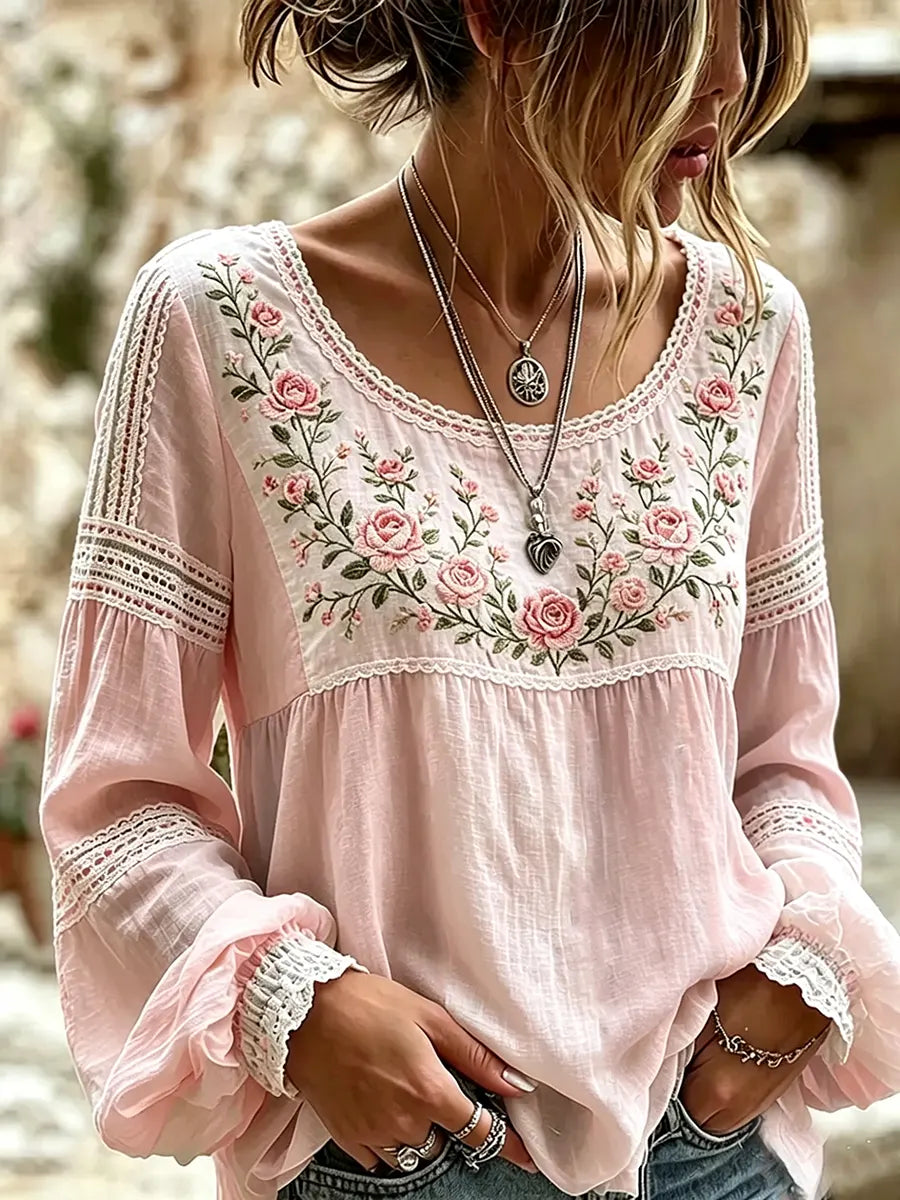 Elegant women's blouse featuring delicate floral embroidery and comfortable relaxed long sleeves.