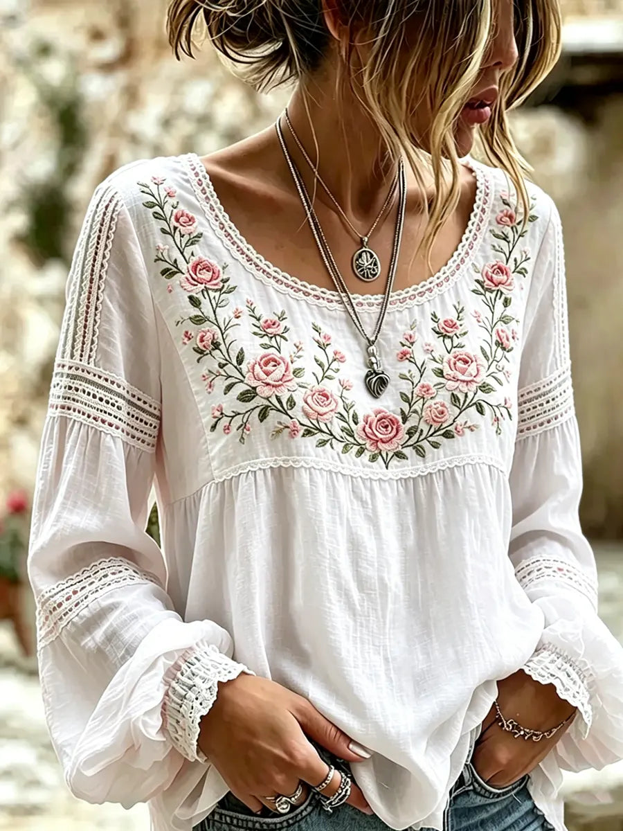 Fashionable women's long sleeve top, intricately embroidered with florals, offering a relaxed and stylish fit.