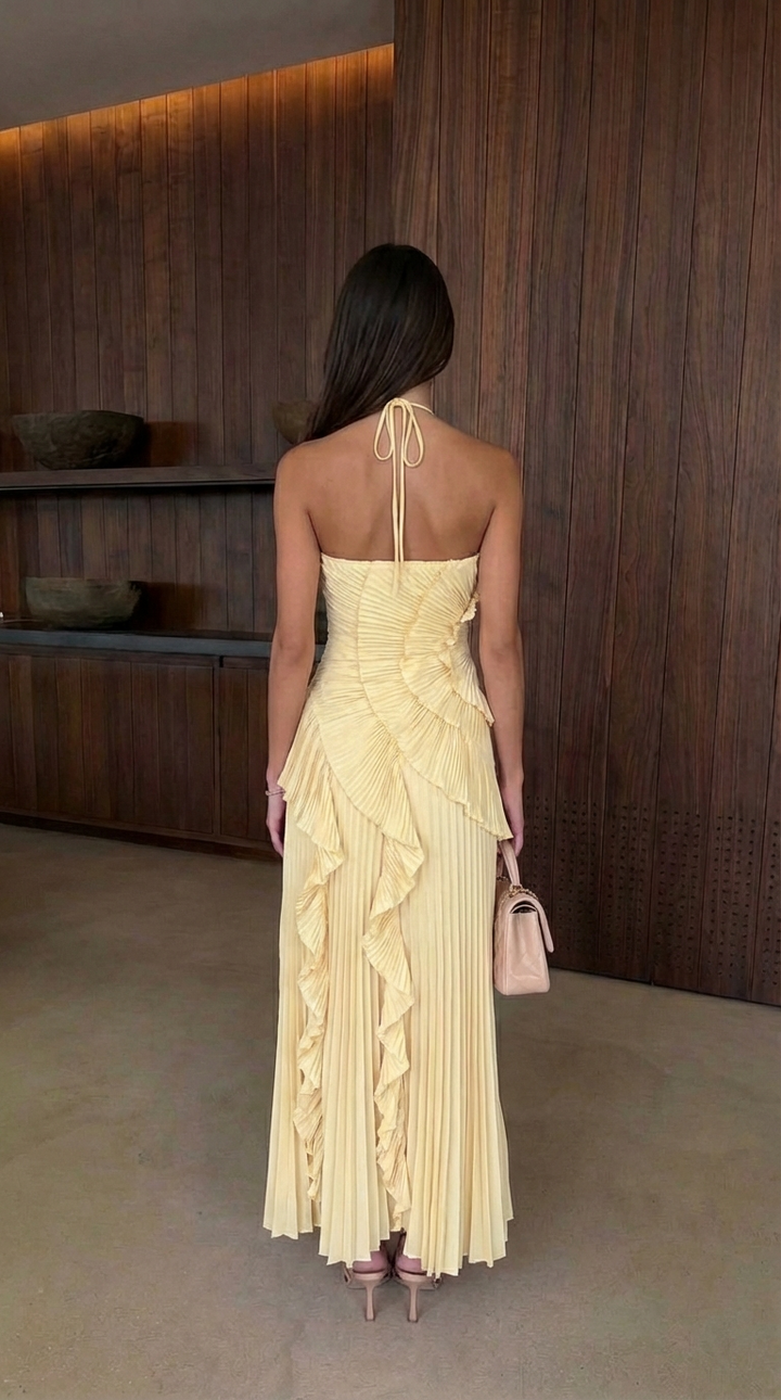 Elegant women's maxi dress featuring a chic halterneck, graceful ruffles, and an eye-catching asymmetric skirt.