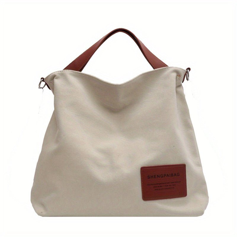 Women's large canvas shoulder tote bag in cream white, perfect for everyday use with an adjustable strap.