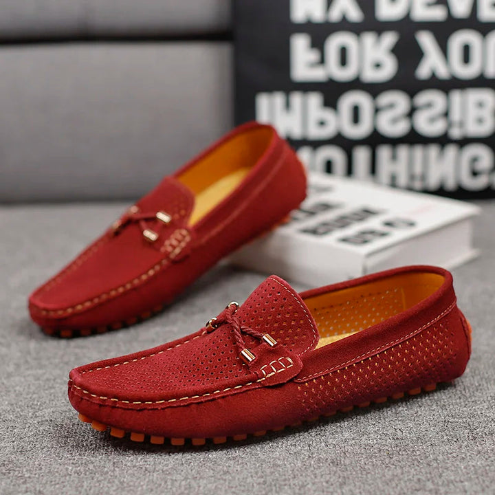 Close-up of men's perforated leather loafers, showcasing breathable design and comfortable slip-on style.