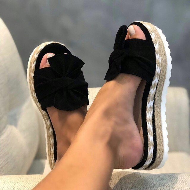 Stylish women's peep-toe wedge sandals with a delicate bow, ideal for dressy or casual summer events.