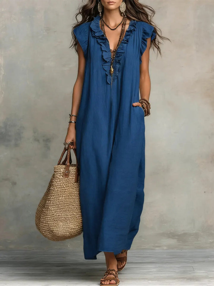 Flowing long summer dress for women, designed with an elegant V-neck and charming ruffle details.