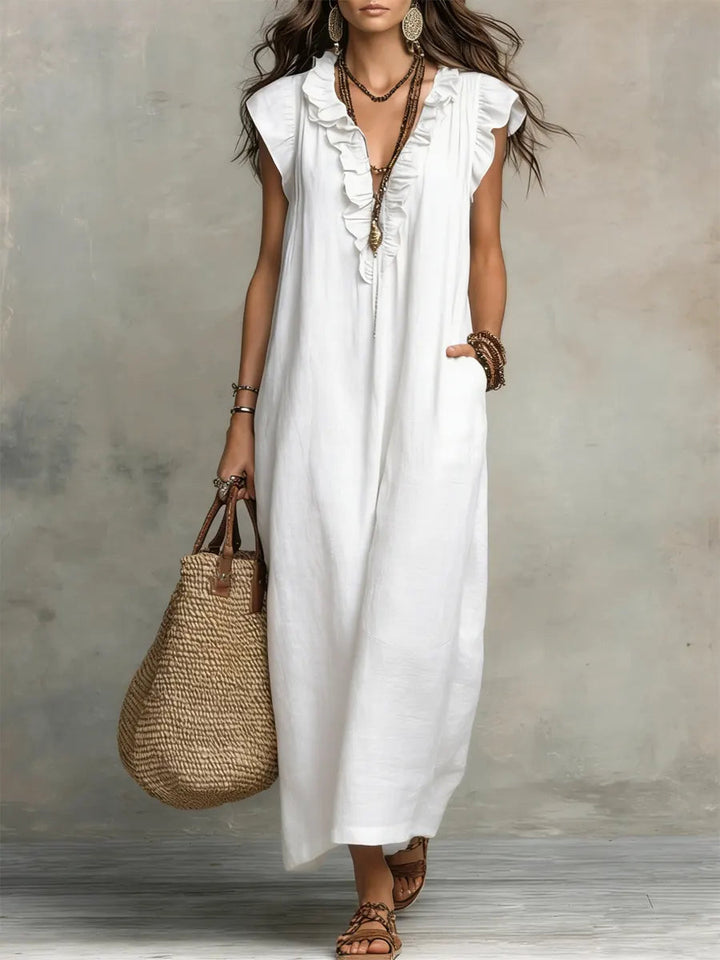 Close-up of the elegant ruffle and V-neck detail on a women's flowing maxi dress.