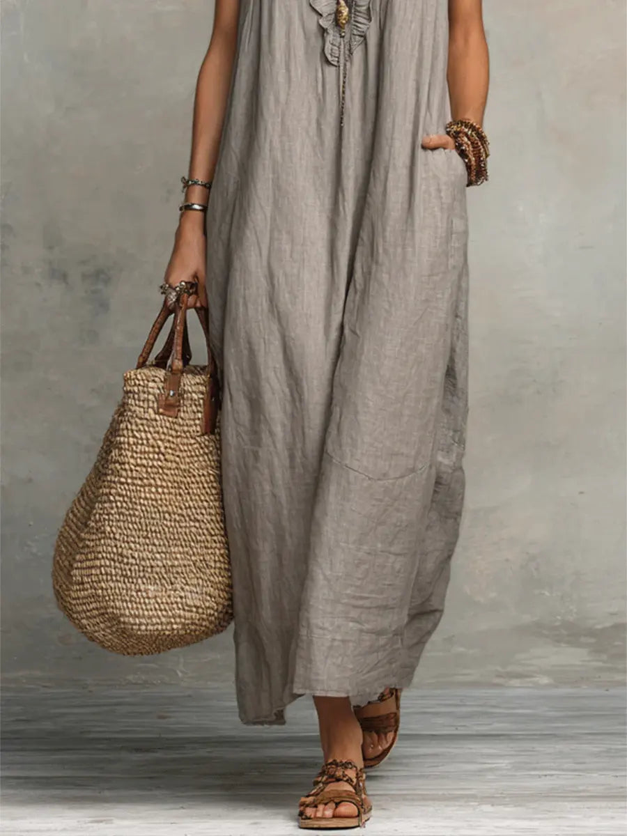 Full-length view of a women's elegant flowing maxi dress with stylish V-neck and ruffle accents.