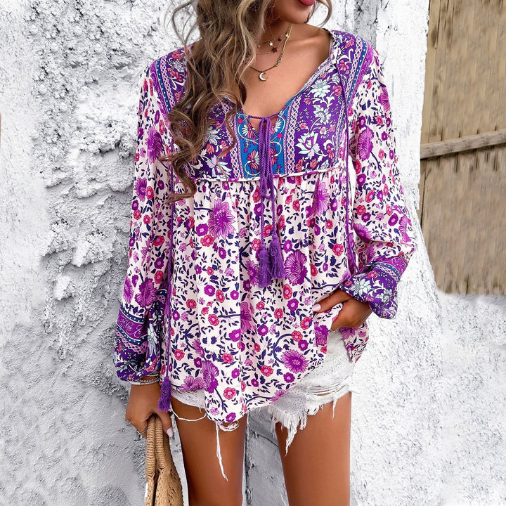 Light & breezy women's floral tunic blouse with long sleeves, a comfortable V-neck for summer fashion.